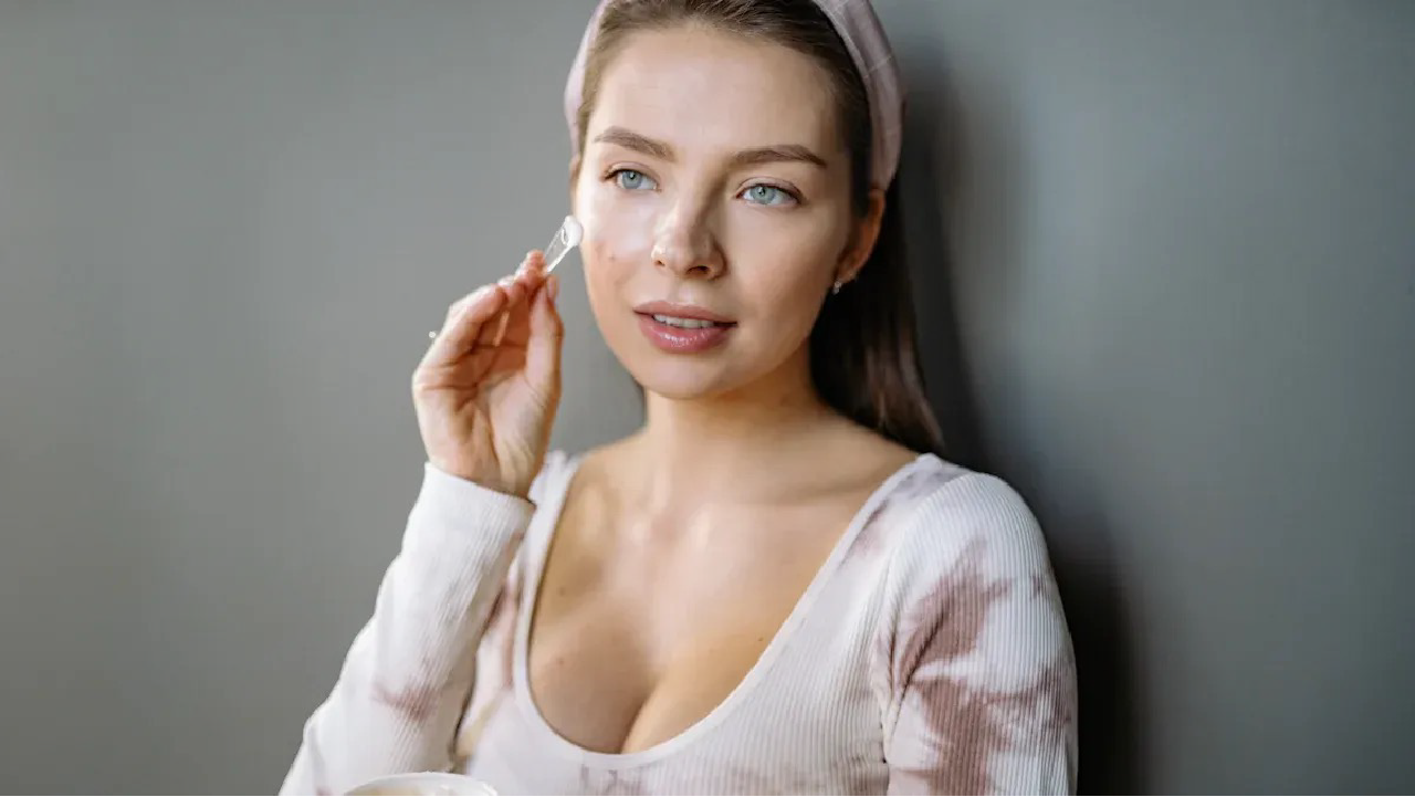 Woman applying skincare, representing how tea antioxidants support youthful skin.