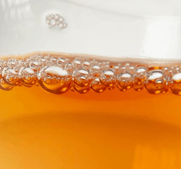 Dahongpao tea liquor showing a deep amber color and natural clarity, reflecting the warmth and depth of Wuyi oolong tea