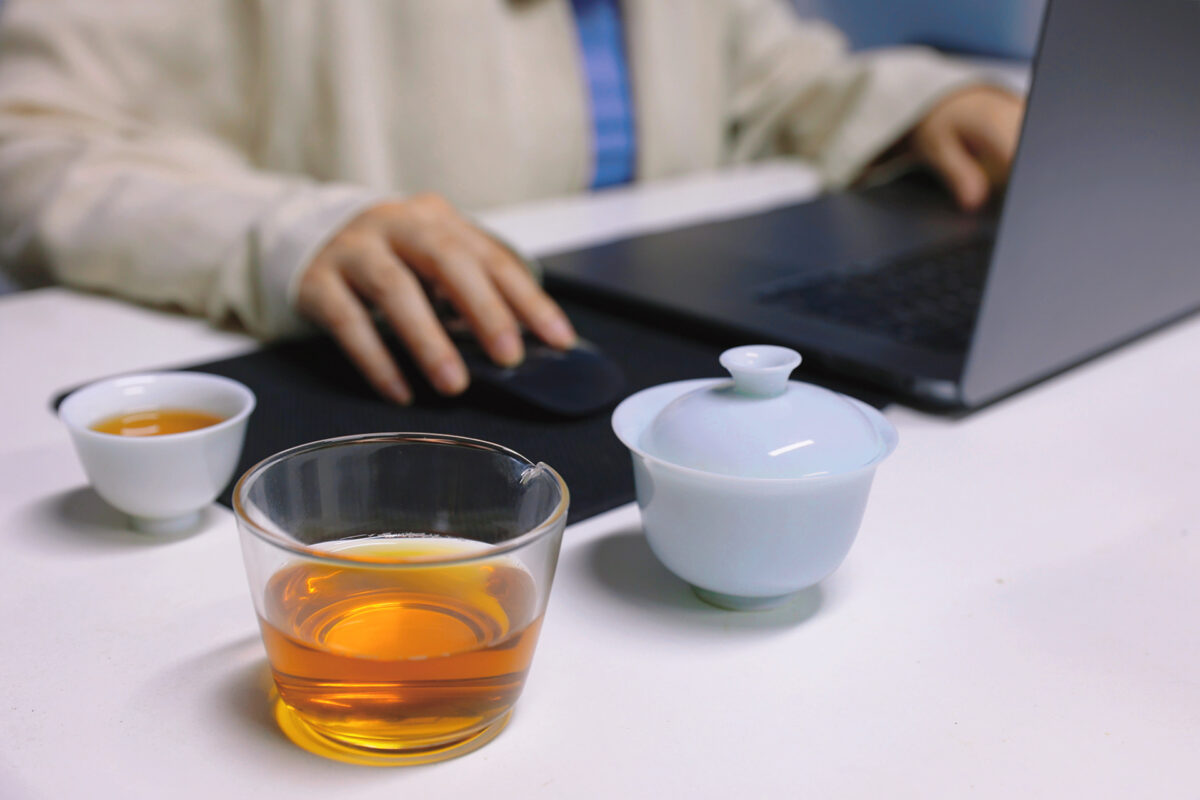 Portable porcelain gongfu tea set on an office desk for a quiet solo tea break during work