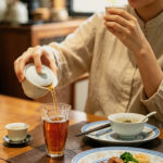 Warm Chinese tea served after a heavy meal in a calm evening dining setting