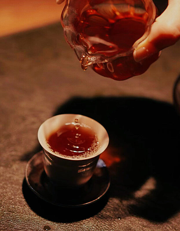 Roasted Wuyi rock tea poured into a small cup after a heavy dinner for grounding and digestion