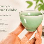 A hand holding a Longquan celadon tea cup, showing the smooth jade-like glaze and tactile feel of Chinese celadon teaware.