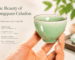 A hand holding a Longquan celadon tea cup, showing the smooth jade-like glaze and tactile feel of Chinese celadon teaware.
