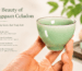 A hand holding a Longquan celadon tea cup, showing the smooth jade-like glaze and tactile feel of Chinese celadon teaware.