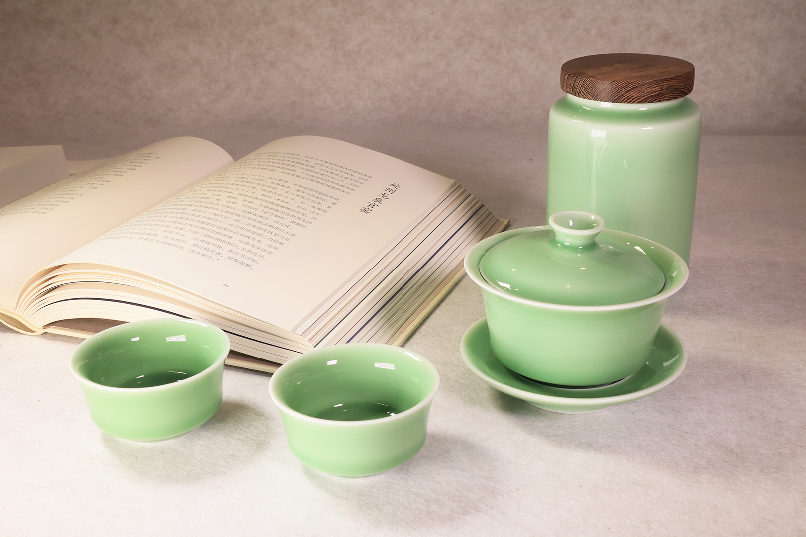 Longquan celadon tea set placed beside an open book for a calm daily tea moment