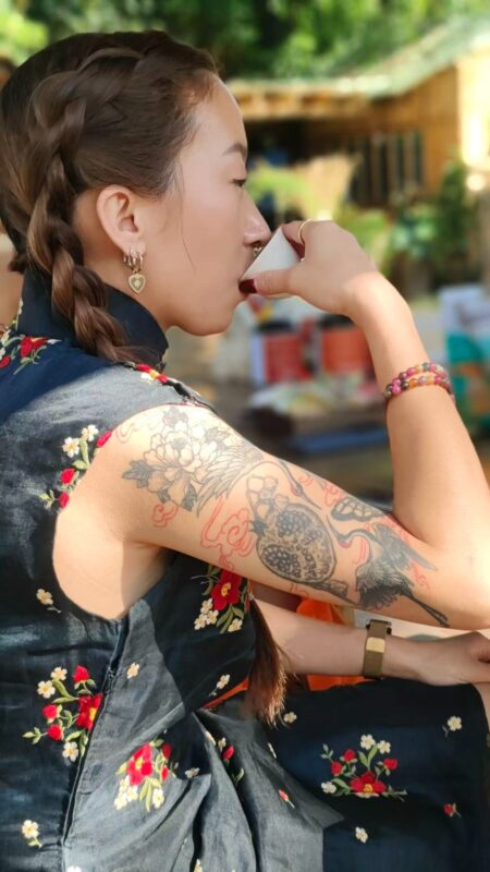 A tea drinker quietly enjoying Chinese tea during a mindful tea moment outdoors.