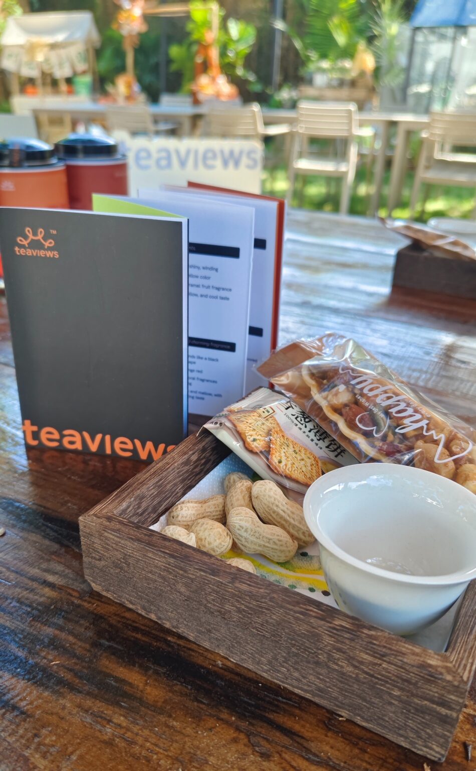 A Teaviews tea session table with tea booklets, cups, snacks, and details prepared for a private tea conversation.