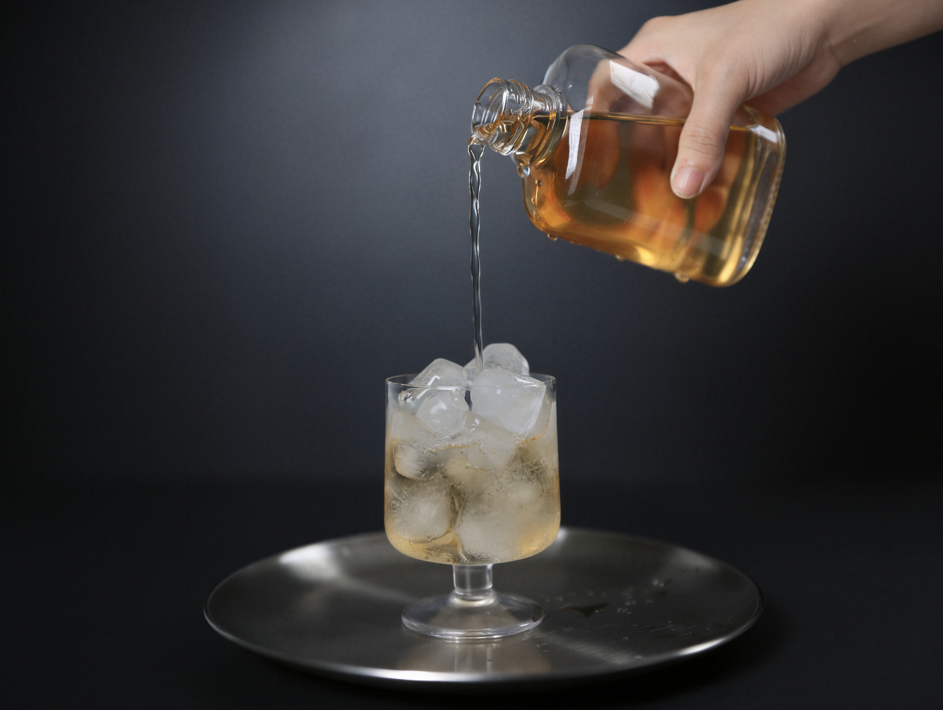 Cold-brewed Jianyang Bai Mu Dan white tea poured over ice with a clear pale-golden liquor.