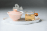 Jianyang Bai Mu Dan white tea served with a gaiwan and clear tea liquor.