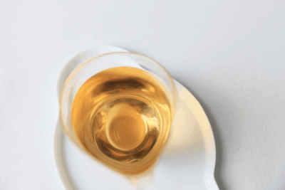 Golden Bai Mu Dan white tea liquor in a glass serving pitcher.