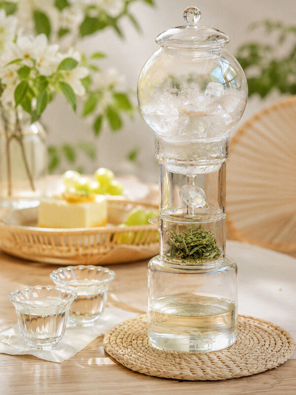 Slow ice brew Chinese tea made with ice cubes and loose leaf tea in a glass dripper
