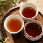Comparison of Wuyi rock tea liquor colors across light roast, medium roast, and traditional roast Yancha.