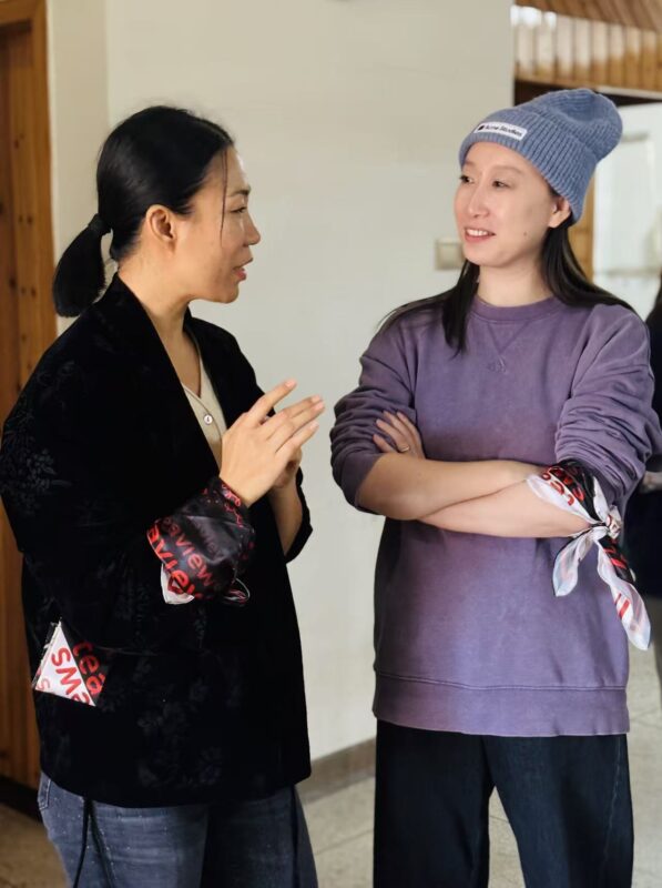 Charlotte Yao and Ling Chen discussing Wuyi Yancha while observing tea maker Liu Dexi at work