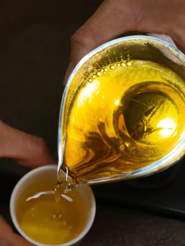 Amber tea glowing in evening light, representing a tea ritual, sensory awareness and reconnecting with everyday life.